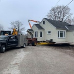 House 28x30ft was moved couple blocks as a new new house was being built on original property. Hydro lifting wires to get house into new lot.