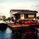 Back Split House 32x65ft moved in Owen Sound to harbor and onto a barge north to Cape Croker.