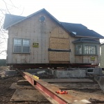 House 30x40ft was relocated 10 blocks away from downtown Kincardine along the river. Land used for a teaching school/office. Prepping house to be rolled off foundation.