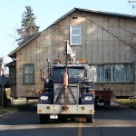 House 30x40ft was relocated 10 blocks away from downtown Kincardine along the river. Land used for a teaching school/office. House being navigated down tight streets.