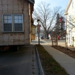 House 30x40ft was relocated 10 blocks away from downtown Kincardine along the river. Land used for a teaching school/office. House being navigated down tight streets past signs.