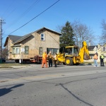 House 30x40ft was relocated 10 blocks away from downtown Kincardine along the river. Land used for a teaching school/office. House being navigated down tight streets. House turning a corner with help from a backhoe.
