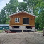 24x50ft cottage in Point Clark was sinking in the back corner. Cottaged rolled out of the way for new full height foundation was poured.